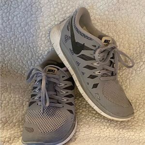 Nike tennis shoes-gray and black. Size kids 5.5 fits 7 in womens.